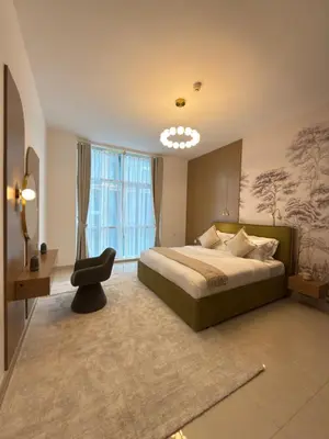 a bedroom with a large bed and a window at Duja Tower in Dubai