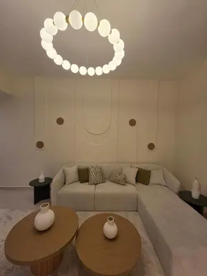 a living room with a couch and two tables at Duja Tower in Dubai