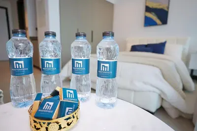 three bottles of water sitting on top of a table at Cozy Studio, All Bills Included in Dubai