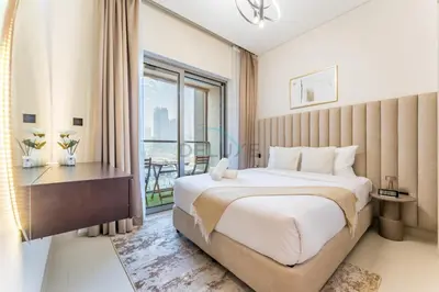 a bedroom with a large bed and a window at Modern Apartment Near Sobha Hartland Amenities, Minutes from Ras Al Khor Wildlife Sanctuary and Downtown Dubai, Sobha Creek Vistas Tower A, Sobha Hartland by Deluxe Holiday Homes in Dubai