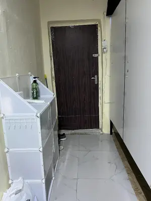 a room with a door and a kitchen with white tile at mixed room jumeirah 1, bed hostel dubai in Dubai
