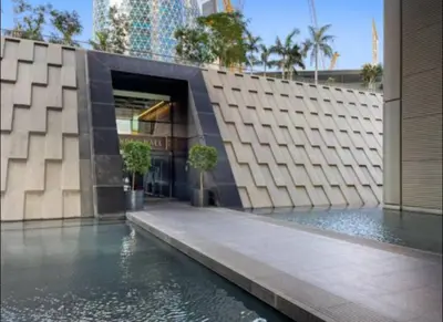 a building with a pool of water in front of it at Index Tower DIFC with Burj Khalifa View Chic 1 BR in Dubai