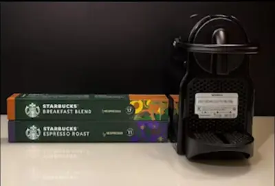 a toaster and a book on a table next to at Index Tower DIFC with Burj Khalifa View Chic 1 BR in Dubai