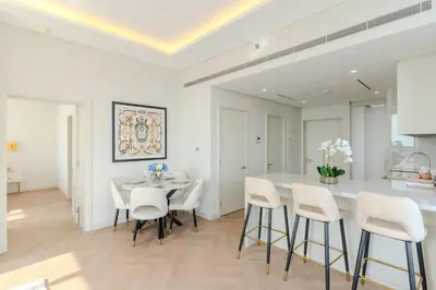 a kitchen and dining room with a table and chairs at Daniels 1BR with Sea View at The Palm Tower in Dubai