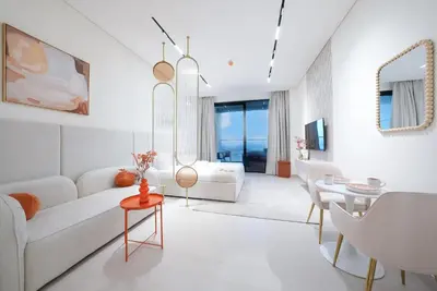 a living room with a white couch and a table at Luxury Trillionaire Studio with Jacuzzi and Canal Views in Business Bay in Dubai