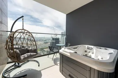 a bath tub in a room with a large window at Luxury Trillionaire Studio with Jacuzzi and Canal Views in Business Bay in Dubai