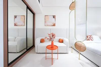a living room with a white couch and a table at Luxury Trillionaire Studio with Jacuzzi and Canal Views in Business Bay in Dubai
