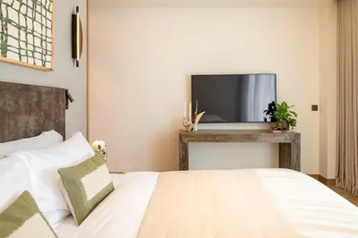 a bedroom with a bed and a flat screen tv at Seraya Residences at Address Opera Dubai in Dubai