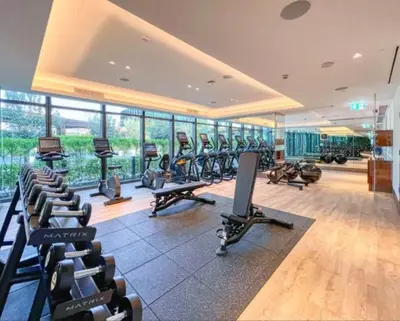 a gym with rows of treadmills and exercise bikes at Seraya Residences at Address Opera Dubai in Dubai