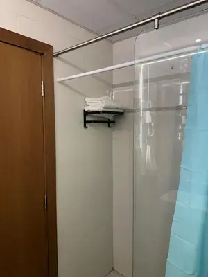 a glass shower in a bathroom with a shelf at Livincci - Luxury Studio Burj Khalifa View - 12 in Dubai