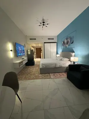 a bedroom with a bed and a tv and a couch at Livincci - Luxury Studio Burj Khalifa View - 12 in Dubai