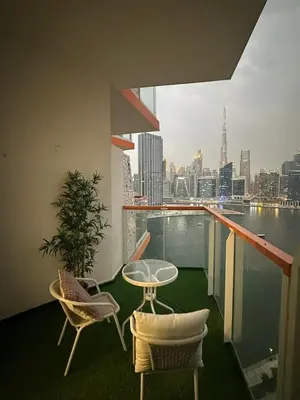 a balcony with a table and chairs and a view of the city at Livincci - Luxury Studio Burj Khalifa View - 12 in Dubai