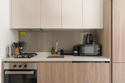 a kitchen with a sink and a microwave at Elegant Studio in Peninsula One, Business Bay in Dubai