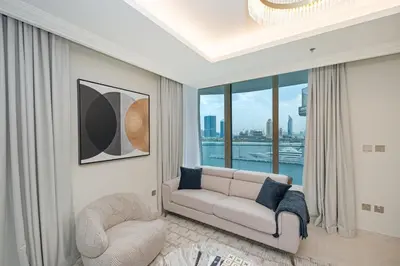 a living room with a couch and a large window at Beach access 2BR with Balcony & Sea View in Dubai