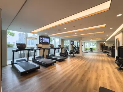 a gym with treadmills and exercise equipment in a building at Beach access 2BR with Balcony & Sea View in Dubai