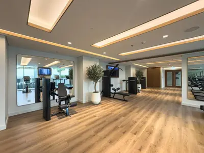 a large room with a gym with desks and chairs at Beach access 2BR with Balcony & Sea View in Dubai