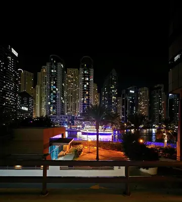a view of a city skyline at night at Come experience Dubai Marina with luxury capsule in Dubai