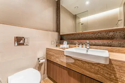 a bathroom with a sink and a toilet and a mirror at Breathtaking Burj Khalifa Views from a High-Floor 3BR with an Assistant Room, Just Minutes from Dubai Mall and Downtown Attractions, Imperial Avenue, Downtown Dubai by Deluxe Holiday Homes in Dubai