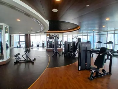 a gym with treadmills and exercise equipment in a building at Breathtaking Burj Khalifa Views from a High-Floor 3BR with an Assistant Room, Just Minutes from Dubai Mall and Downtown Attractions, Imperial Avenue, Downtown Dubai by Deluxe Holiday Homes in Dubai