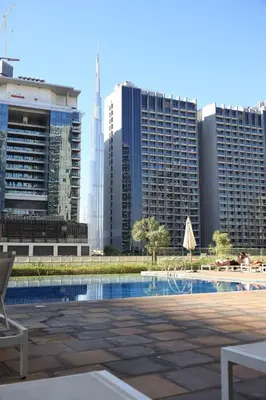 a pool in a city with tall buildings at 1Bedroom Canal View near Dubai Mall-Business Bay in Dubai