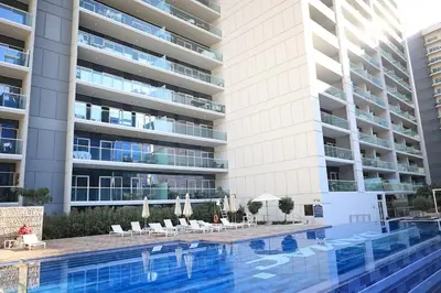 a swimming pool in front of a building at 1Bedroom Canal View near Dubai Mall-Business Bay in Dubai