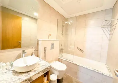 a bathroom with a sink and a toilet and a tub at Dream Shoma- Experience Luxury Living 2BR APT in Dubai