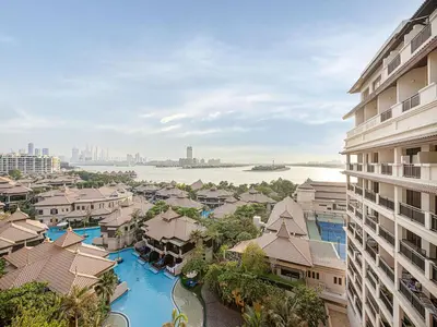 an aerial view of a resort with a river and buildings at Livin' Holidays - 1 BR - Anantara Lagoon Stay in Dubai