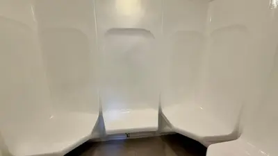 a row of white urinals in a room at Duja Tower 4114 in Dubai