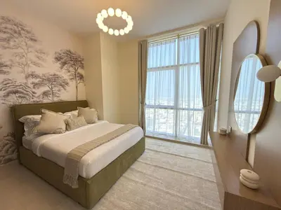 a bedroom with a bed and a large window at Duja Tower 4114 in Dubai