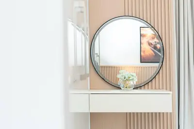 a mirror on a shelf with a vase of flowers at PVH - Stunning 2BR - Creek Vistas Grande in Dubai