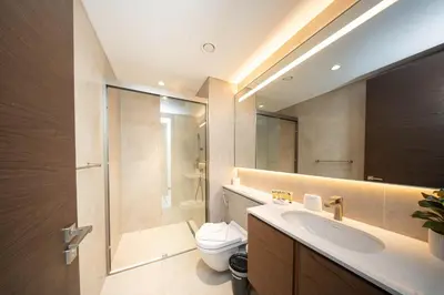 a bathroom with a toilet and a sink and a shower at PVH - Stunning 2BR - Creek Vistas Grande in Dubai