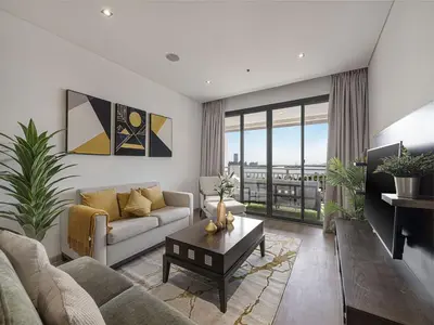 a living room with a couch and a table at Livin' Holidays - 2 BR - Anantara Palm Stay in Dubai