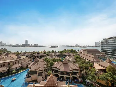 an aerial view of a resort with a body of water at Livin' Holidays - 2 BR - Anantara Palm Stay in Dubai