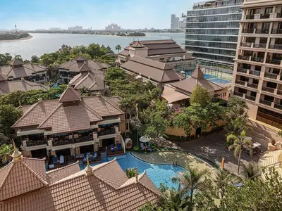 an aerial view of a resort with a swimming pool at Livin' Holidays - 2 BR - Anantara Palm Stay in Dubai
