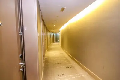a long hallway with a long floor and a wall at Modern 1BHK With World Class Amenities at Paramount Tower in Dubai