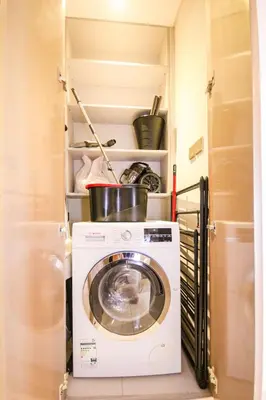a washer and dryer in a small room at Modern 1BHK With World Class Amenities at Paramount Tower in Dubai