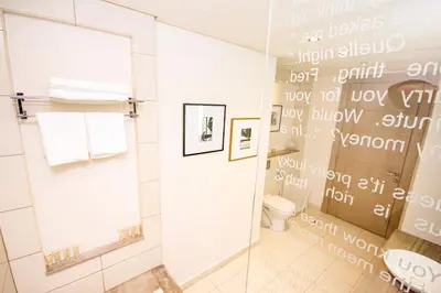 a bathroom with a shower and a toilet and a mirror at Modern 1BHK With World Class Amenities at Paramount Tower in Dubai