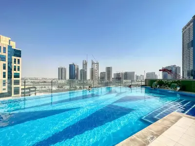 a swimming pool with a city skyline in the background at Studio in downtown of Dubai in Dubai
