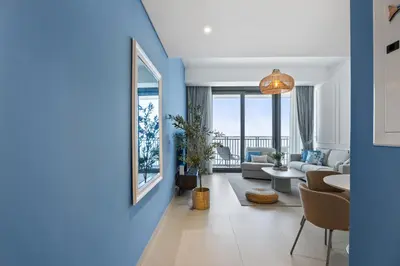 a living room with a blue wall at Luxury Seaview Apartment Near Bluewaters & JBR in Dubai