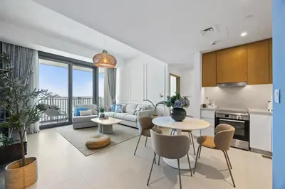 a kitchen and living room with a table and chairs at Luxury Seaview Apartment Near Bluewaters & JBR in Dubai