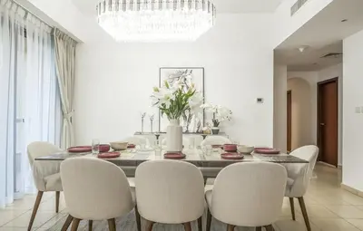 a dining room with a table and chairs at Rimal 1 JBR Beach Access 3 BR in Dubai
