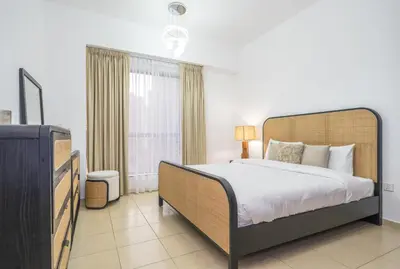 a bedroom with a large bed and a television at Rimal 1 JBR Beach Access 3 BR in Dubai
