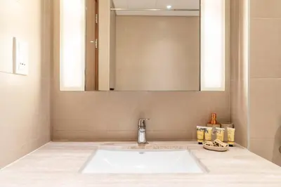 a bathroom with a sink and a mirror at PVH - Vibrant 1BR near Dubai Opera - BLVD Heights in Dubai