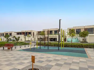 a park with a playground in front of a building at FIRST CLASS 1BR Cozy Luxe Escape in Dubai