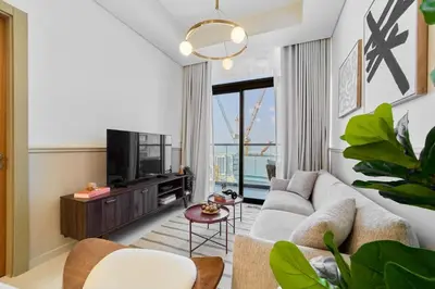 a living room with a couch and a tv at FAM Living - 2 Bedroom Aykon City Dubai in Dubai