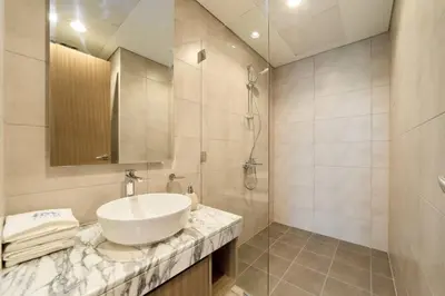 a bathroom with a sink and a shower at FAM Living - 2 Bedroom Aykon City Dubai in Dubai