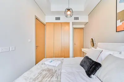 a bedroom with a bed with a towel on it at FAM Living - 2 Bedroom Aykon City Dubai in Dubai
