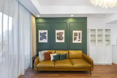 a living room with a yellow couch and a green wall at Stylish 1BR Canal View & 12 min to Downtown in Dubai