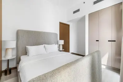 a bedroom with a white bed and a chair at Luxury Suite Huge Terrace Canal and Gevora Views with Infinity Pool in Dubai