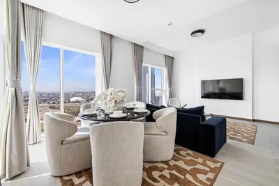 a living room with a dining room table and chairs at Luxury Suite Huge Terrace Canal and Gevora Views with Infinity Pool in Dubai